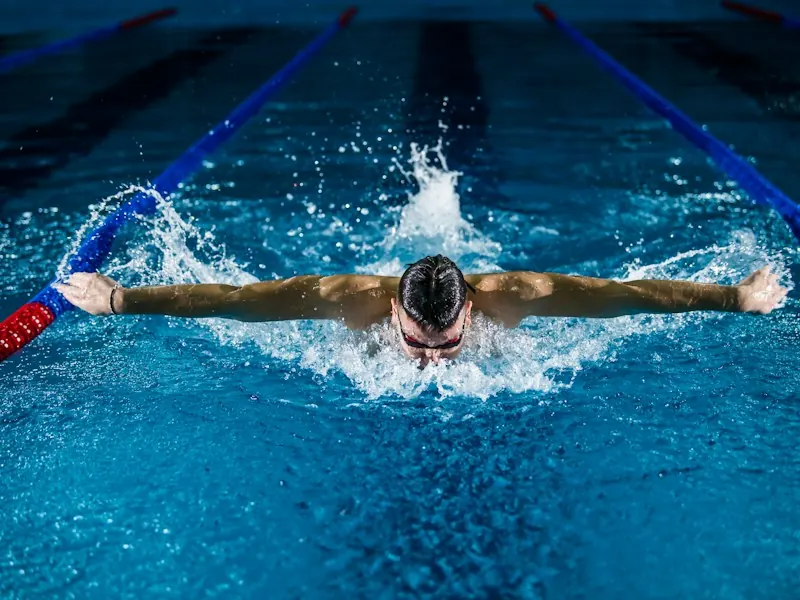 Swimmer training butterfly stroke in a competition pool